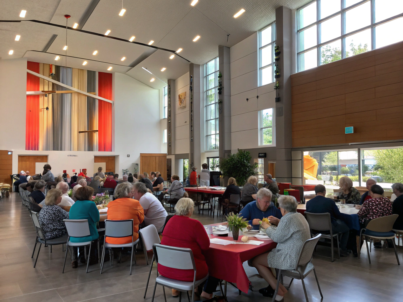 Bright, spacious civic assembly hall with timber flooring, dual presentation screens and flexible seating